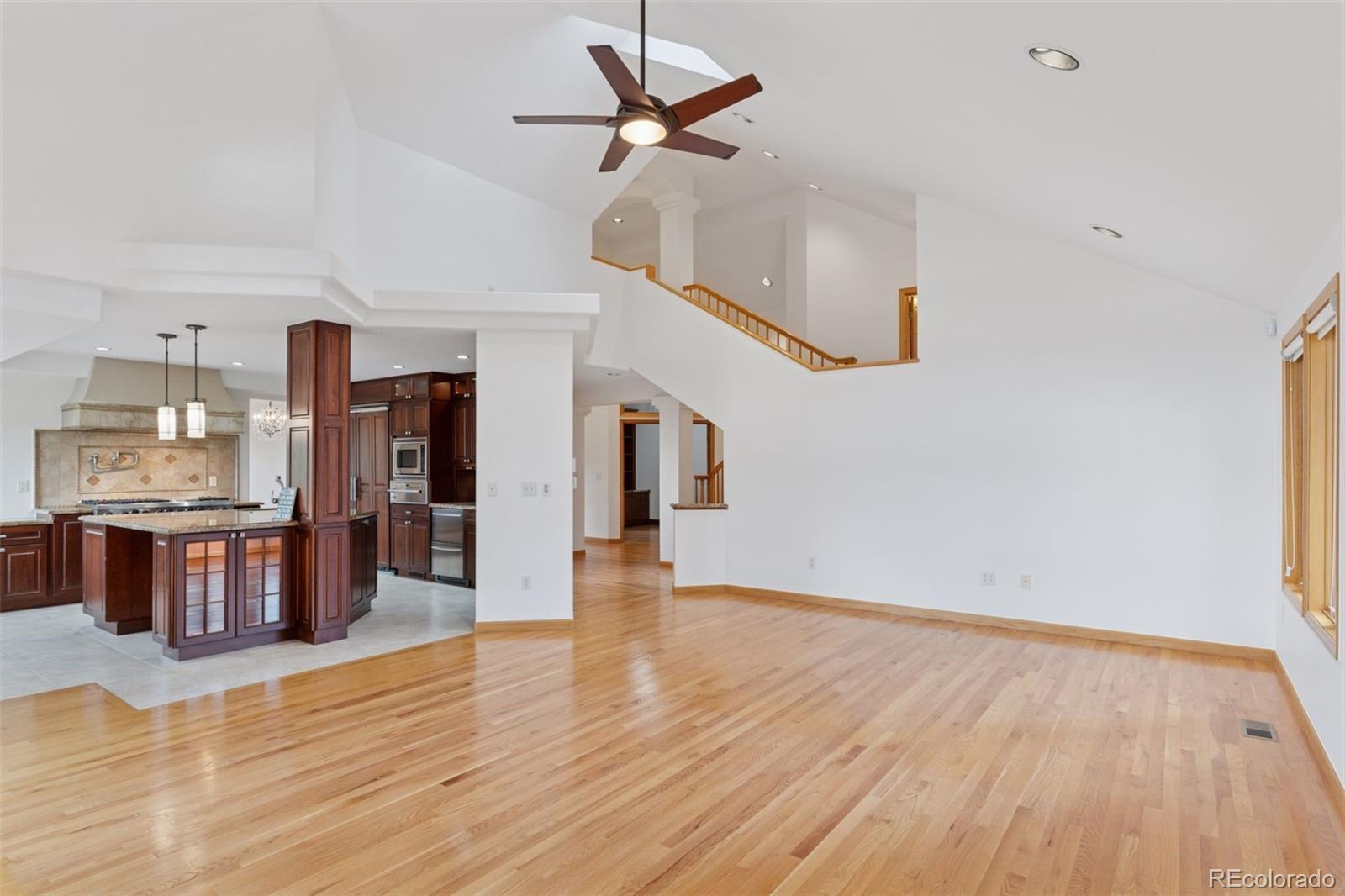 990 Utica Circle Boulder, CO 80304 - Photo 11 of 48 a view of a kitchen with wooden floor and a ceiling fan
