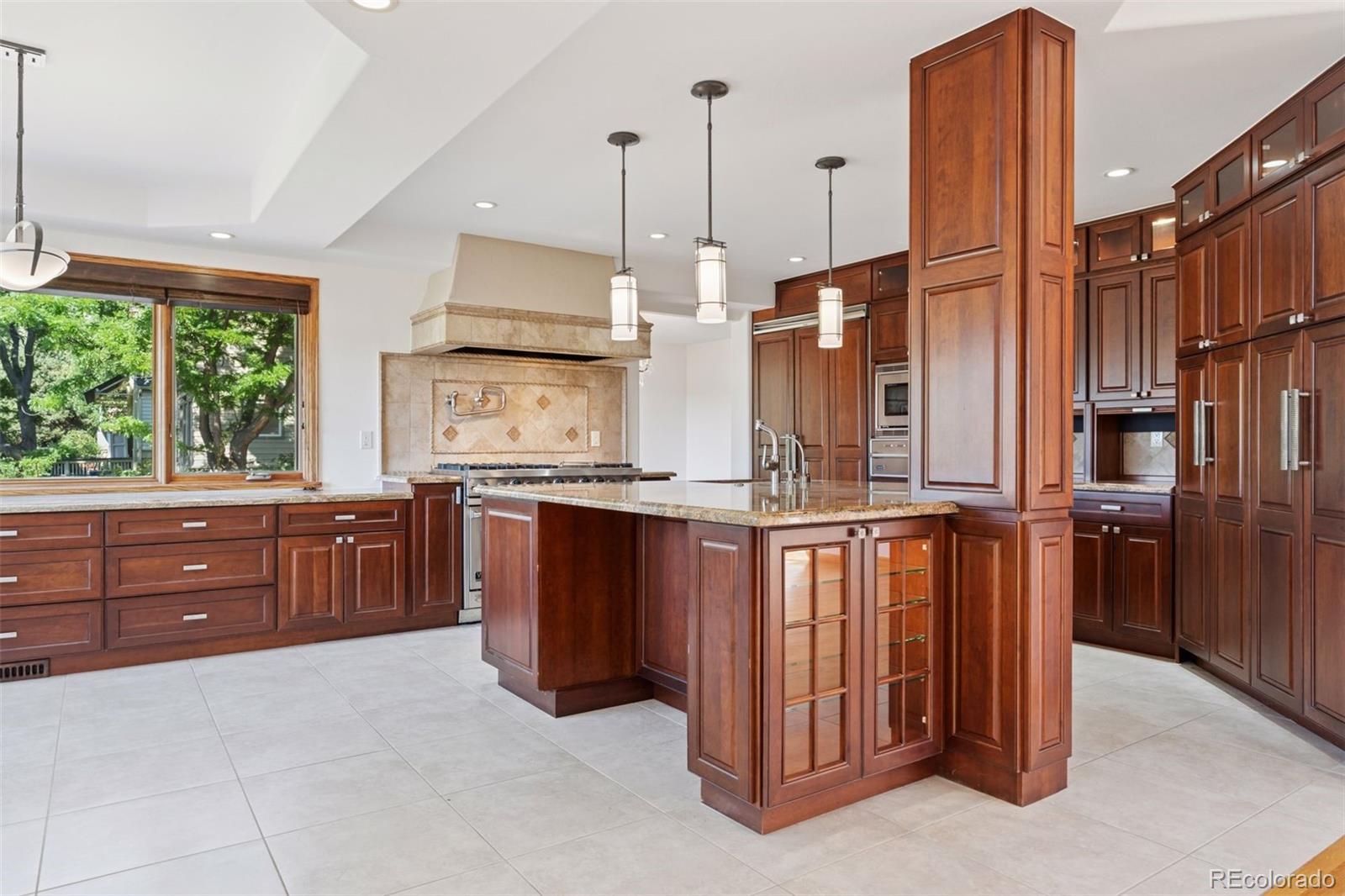 990 Utica Circle Boulder, CO 80304 - Photo 12 of 48 a kitchen with stainless steel appliances granite countertop a stove a sink and a refrigerator