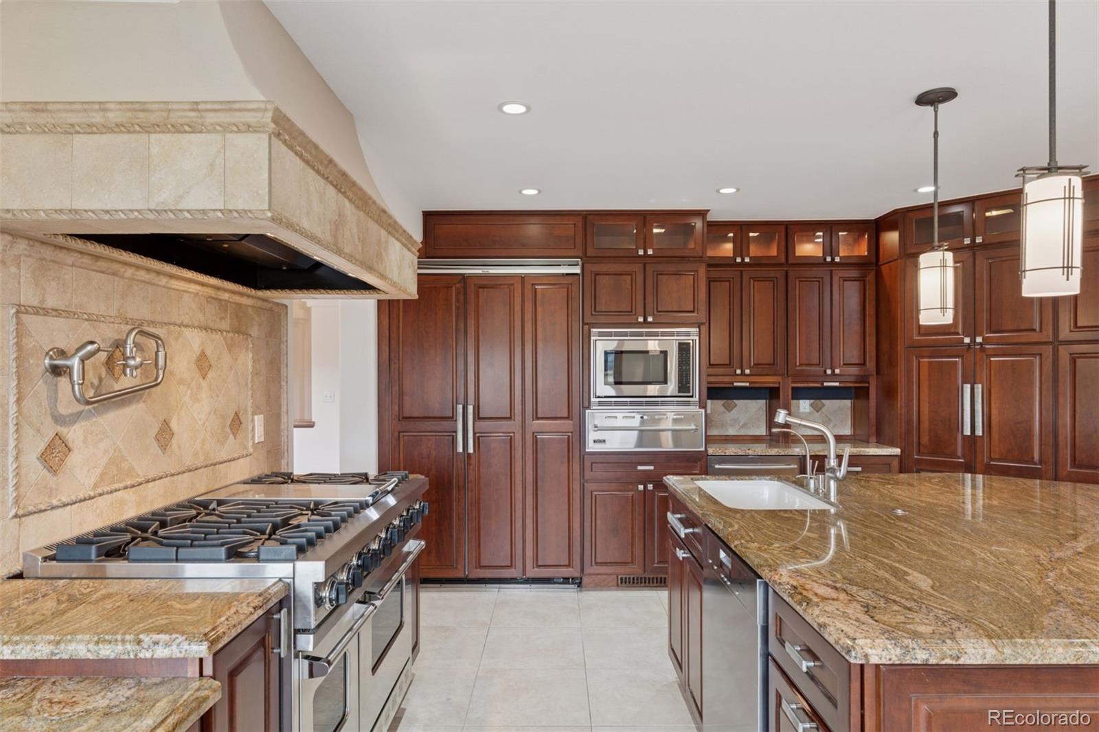990 Utica Circle Boulder, CO 80304 - Photo 13 of 48 a kitchen with stainless steel appliances granite countertop a sink stove and refrigerator