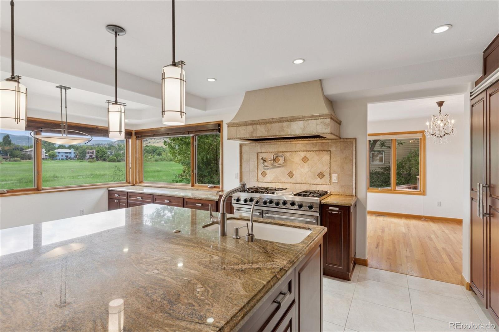 990 Utica Circle Boulder, CO 80304 - Photo 14 of 48 a kitchen with stainless steel appliances granite countertop a stove a sink and a refrigerator