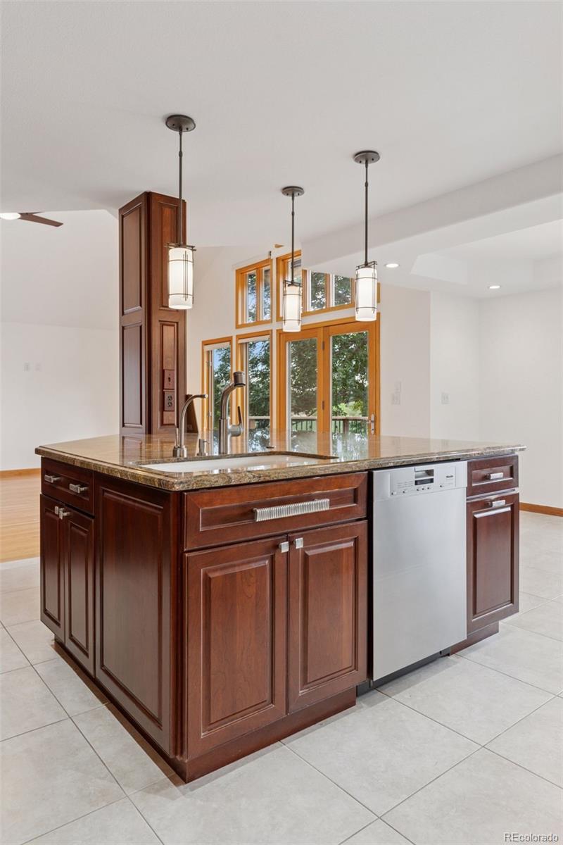 990 Utica Circle Boulder, CO 80304 - Photo 16 of 48 a kitchen with stainless steel appliances granite countertop a stove a sink and a refrigerator