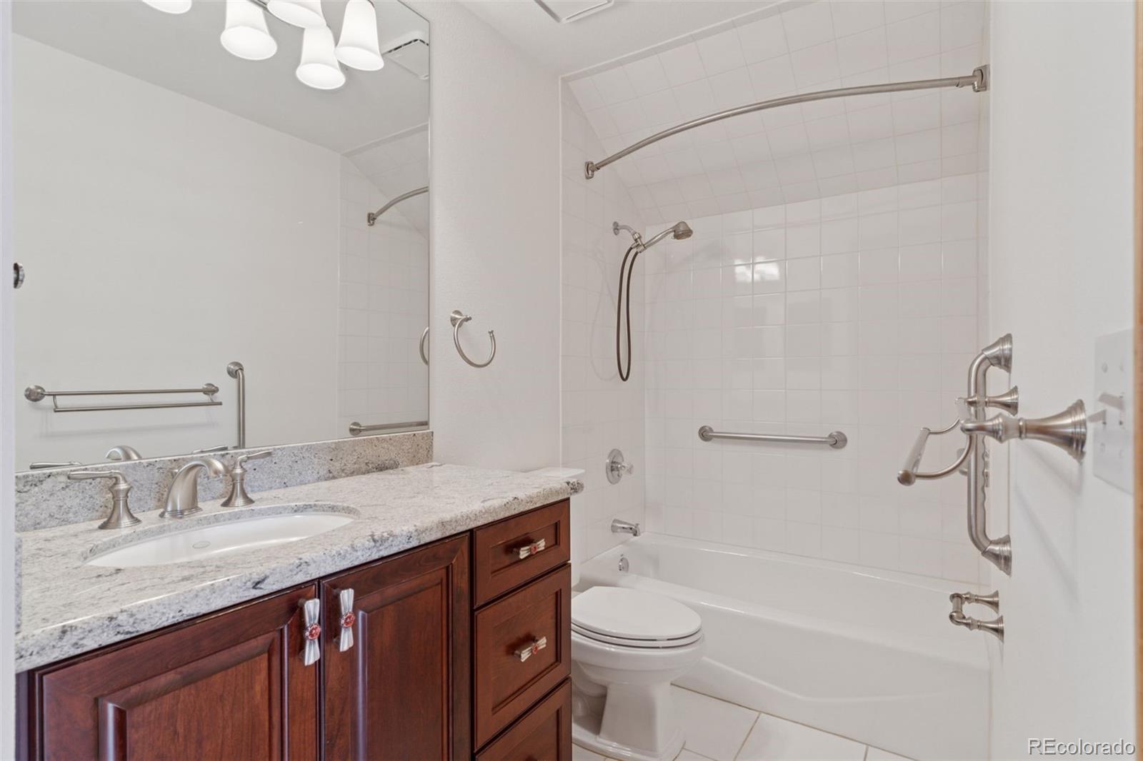 990 Utica Circle Boulder, CO 80304 - Photo 24 of 48 a bathroom with a granite countertop sink toilet and shower