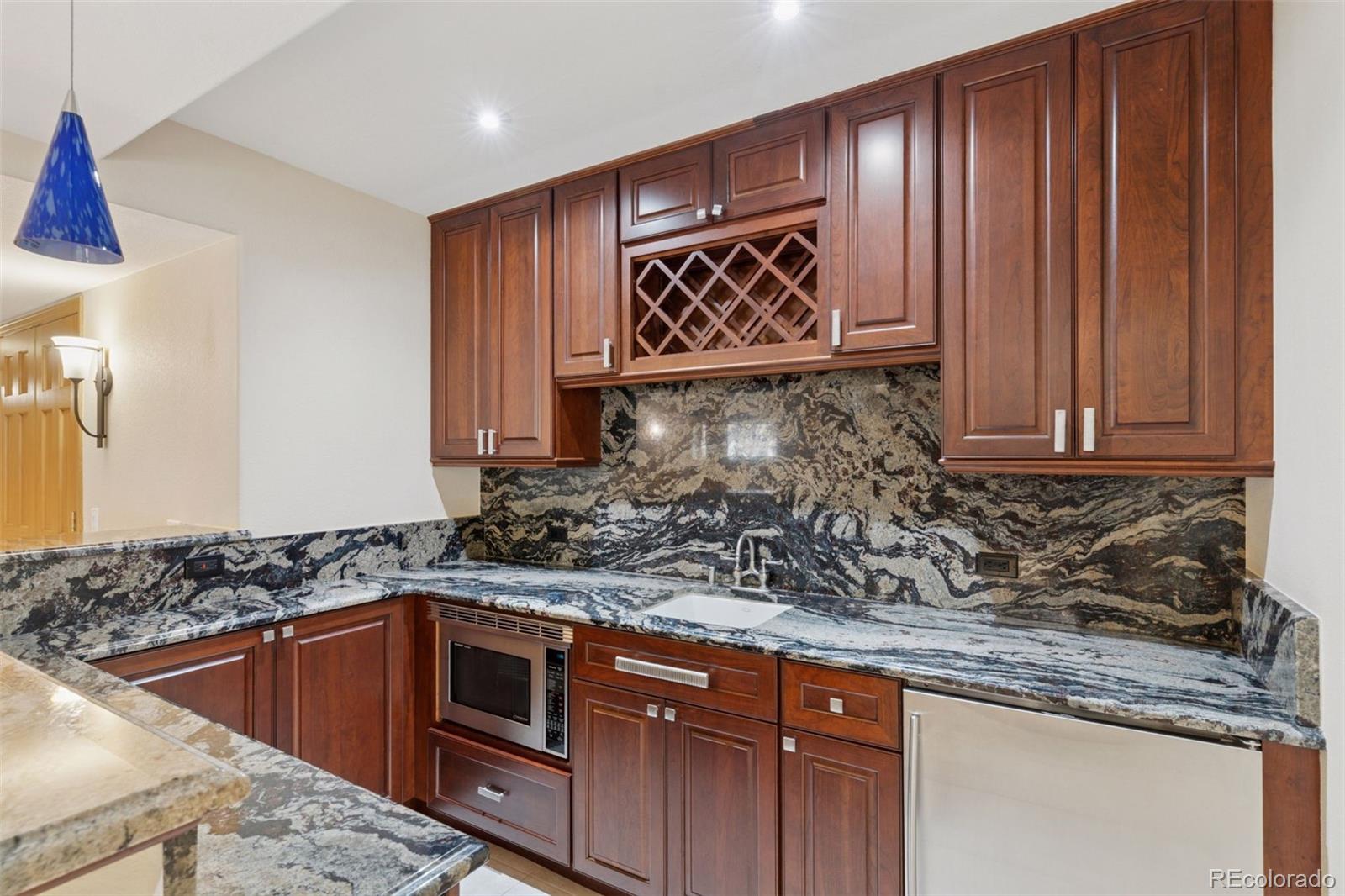 990 Utica Circle Boulder, CO 80304 - Photo 33 of 48 a kitchen with stainless steel appliances granite countertop a sink and a granite counter tops
