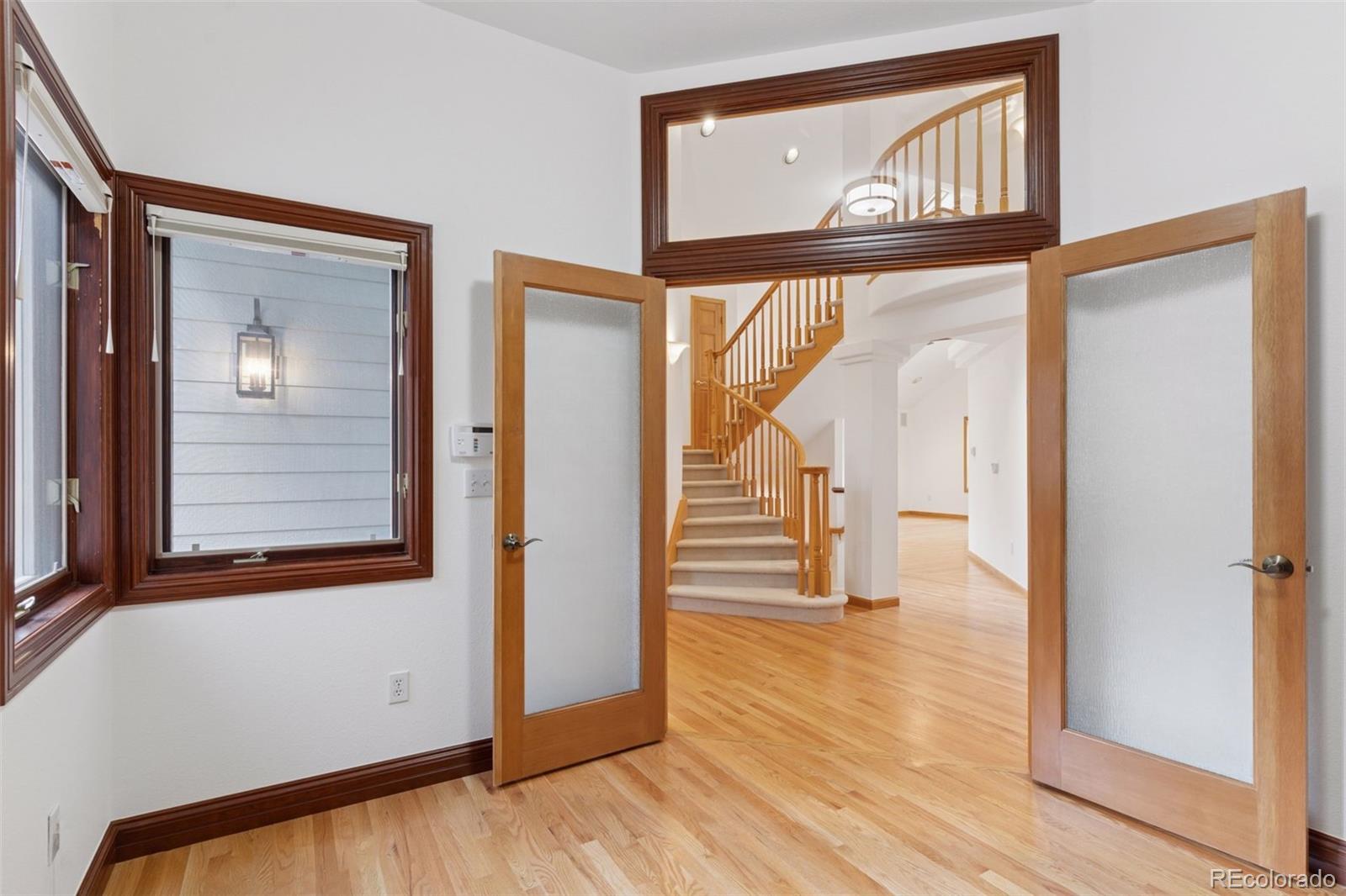 990 Utica Circle Boulder, CO 80304 - Photo 7 of 48 a view of a hallway with wooden floor and staircase