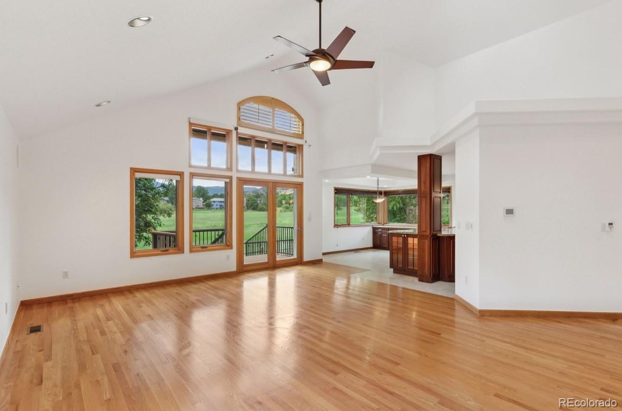 990 Utica Circle Boulder, CO 80304 - Photo 9 of 48 a view of an empty room with a window and wooden floor