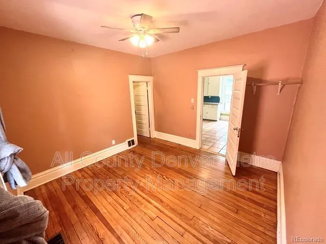 a bedroom with a bed and a view of kitchen
