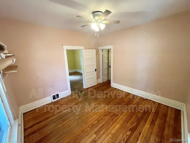 a view of a balcony with wooden floor and door