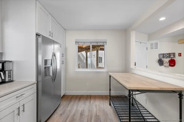a kitchen with stainless steel appliances cabinets and wooden floor