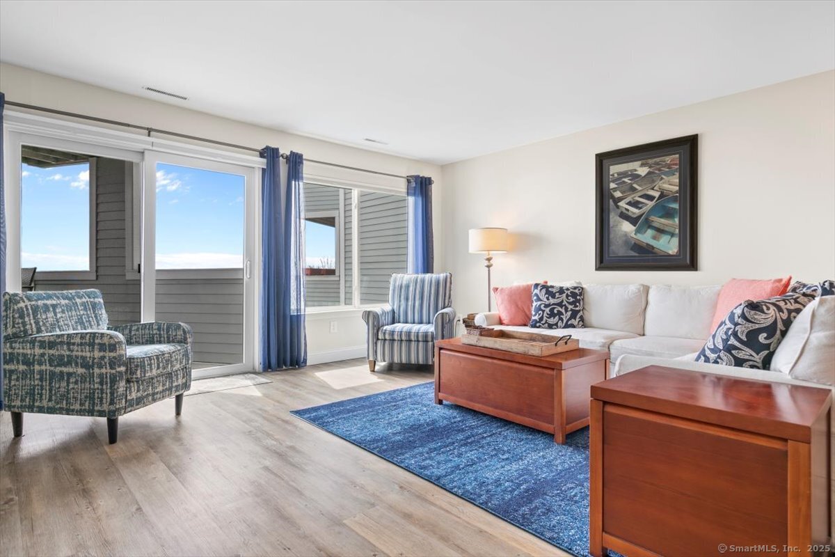 1 Mansfield Grove Road, Unit 206 East Haven, CT 06512 - Photo 12 of 40 a living room with furniture and a wooden floor