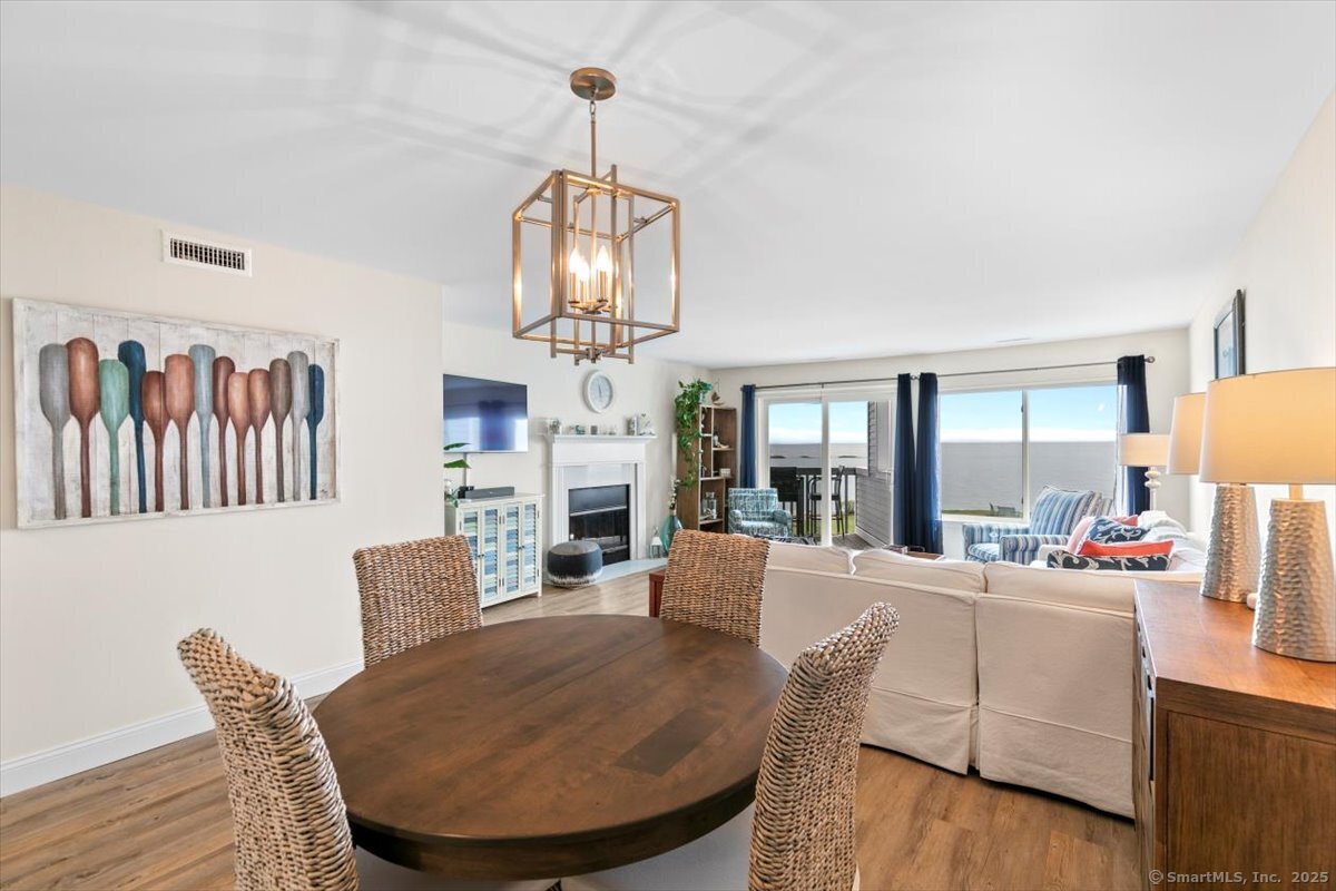 1 Mansfield Grove Road, Unit 206 East Haven, CT 06512 - Photo 15 of 40 a view of a dining room with furniture wooden floor and chandelier
