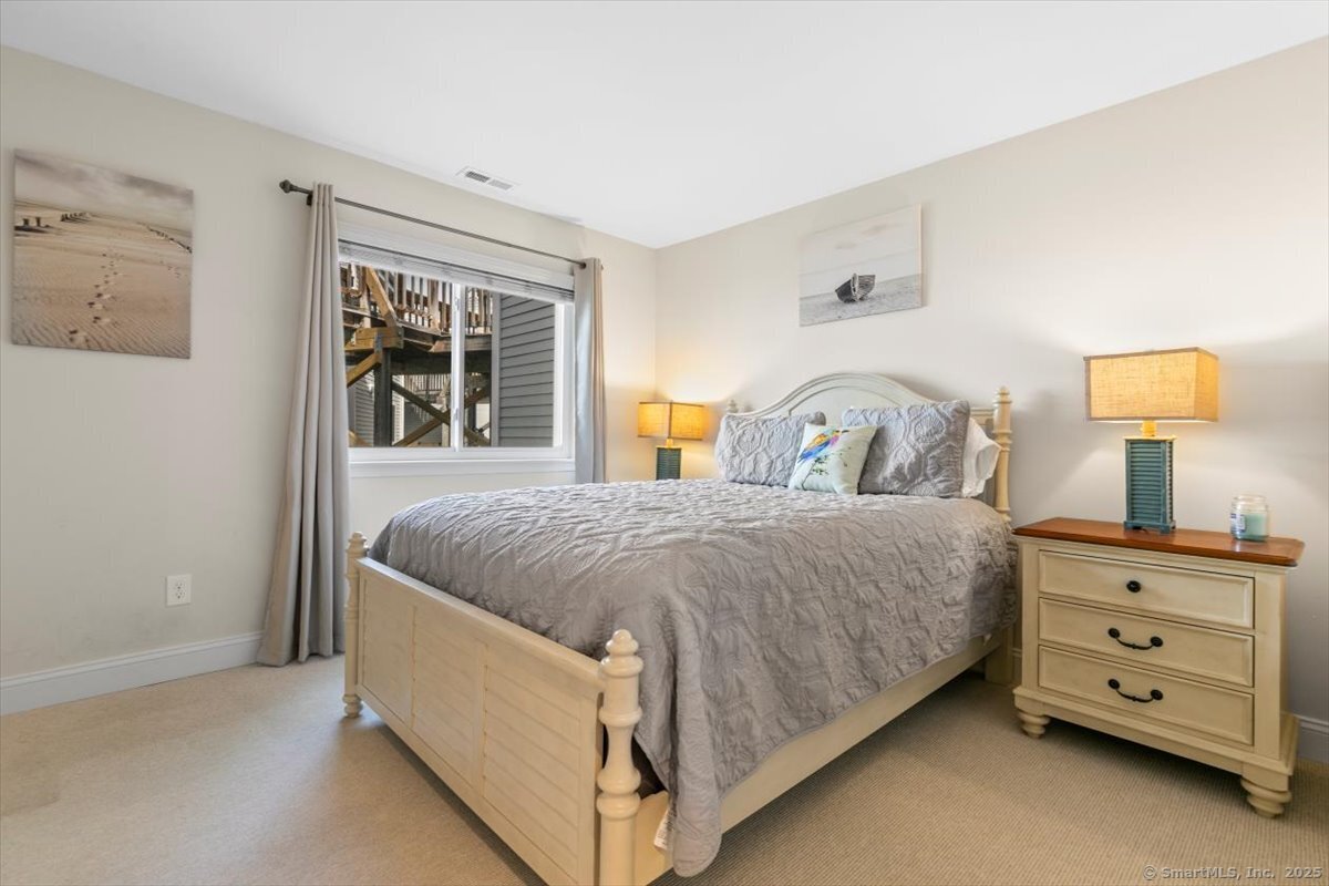 1 Mansfield Grove Road, Unit 206 East Haven, CT 06512 - Photo 19 of 40 a spacious bedroom with a bed and a dresser