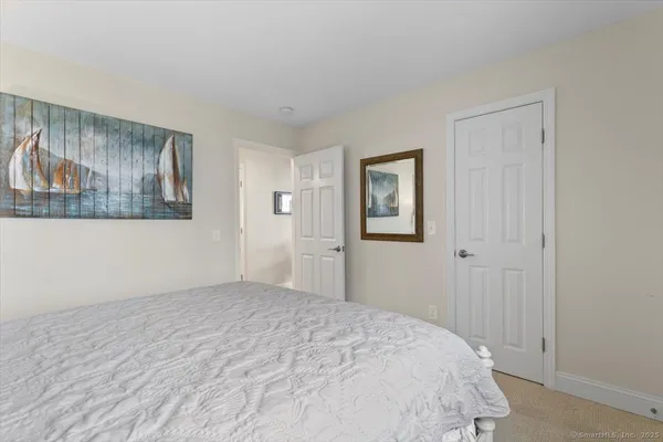 a spacious bedroom with a bed and a dresser