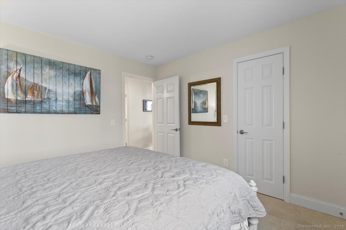 1 Mansfield Grove Road, Unit 206 East Haven, CT 06512 - Photo 20 of 40 a bedroom with a bed and painting on the wall