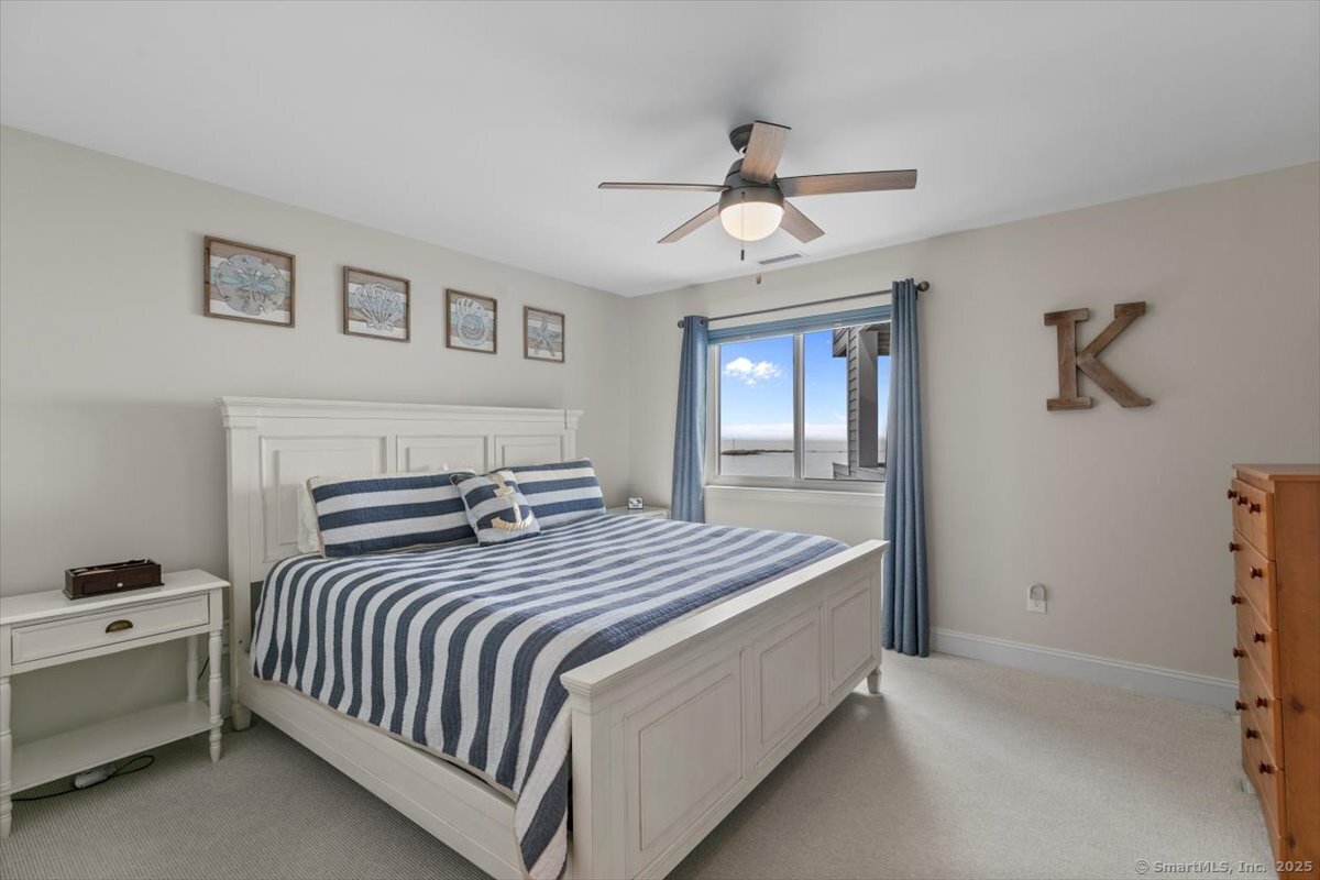 1 Mansfield Grove Road, Unit 206 East Haven, CT 06512 - Photo 26 of 40 a bedroom with a large bed and a chandelier