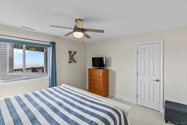 a bedroom with a large bed and a chandelier