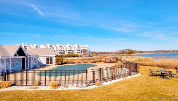 a view of a swimming pool with outdoor seating