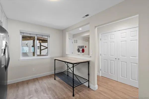 a view of a livingroom with wooden floor and a window