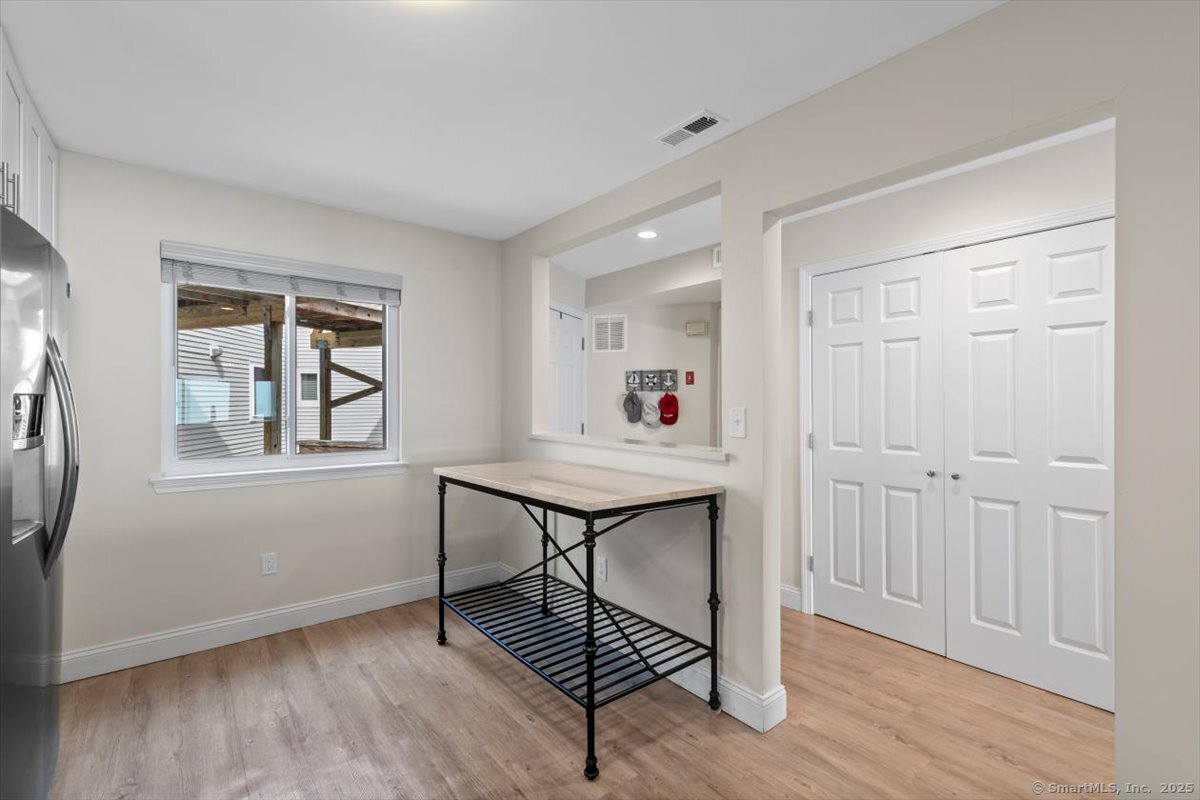 1 Mansfield Grove Road, Unit 206 East Haven, CT 06512 - Photo 8 of 40 a view of a livingroom with wooden floor and a window