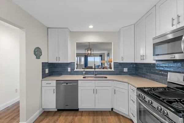 a kitchen with a sink stove and cabinets