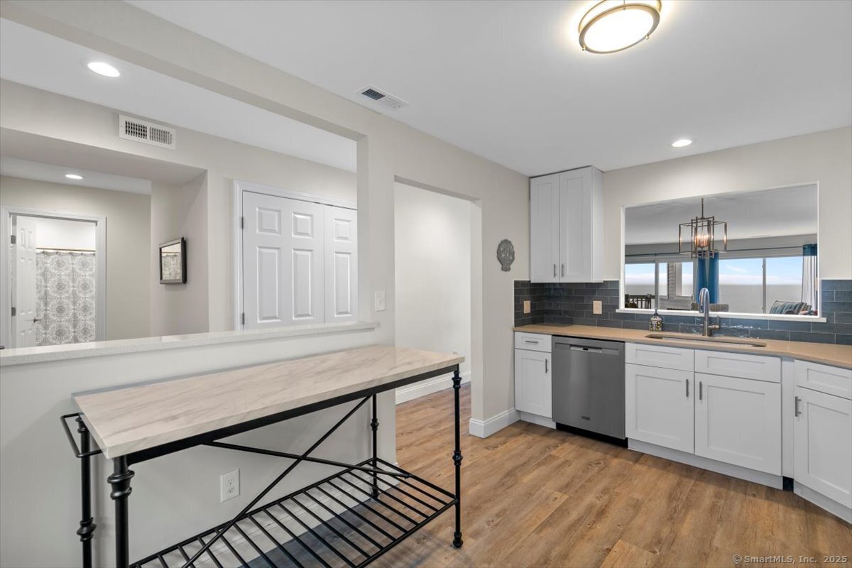 1 Mansfield Grove Road, Unit 206 East Haven, CT 06512 - Photo 10 of 40 a kitchen with stainless steel appliances granite countertop a stove a sink and a refrigerator