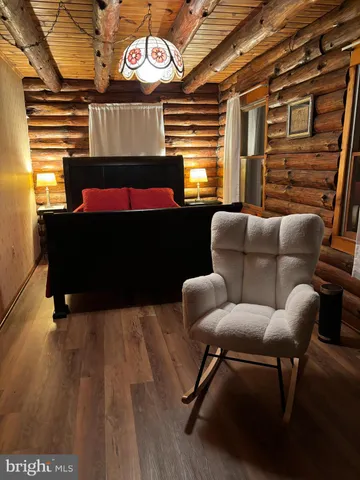 a view of a porch with furniture and wooden floor
