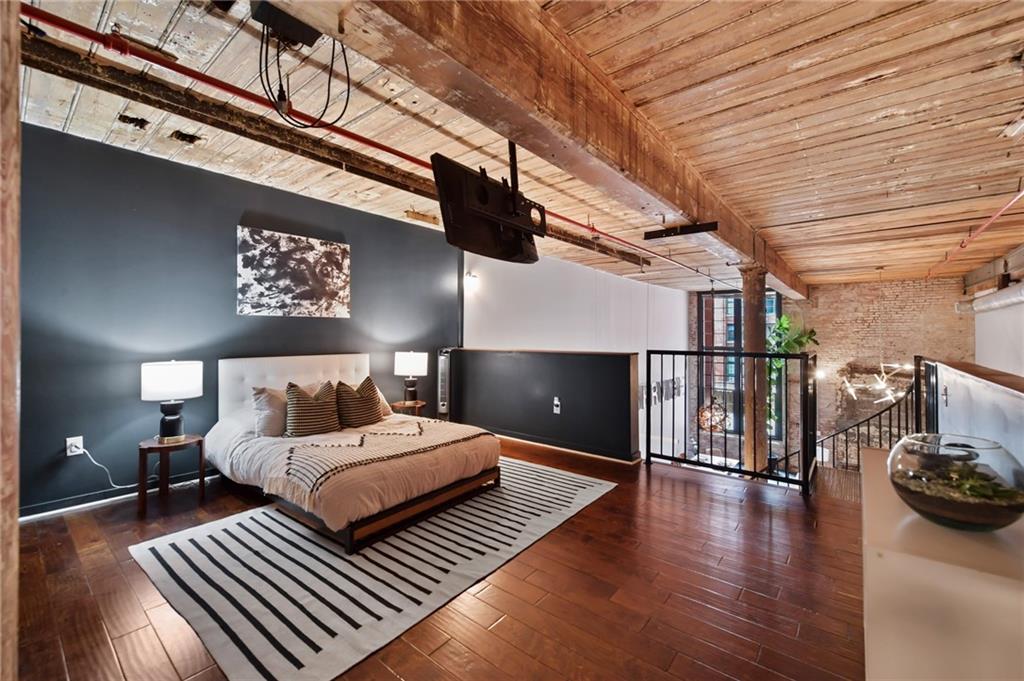 Large primary bedroom overlooking living area.