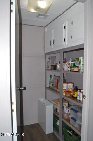 a kitchen with storage and utility