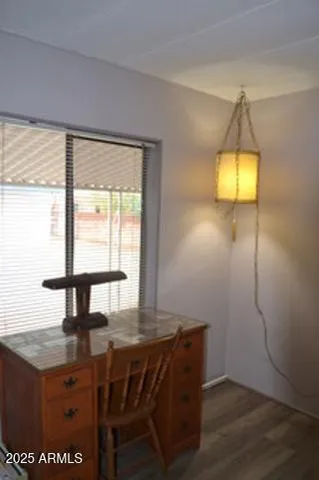 a view of room with wooden floor and a window