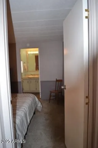 a bedroom with a bed and lamp