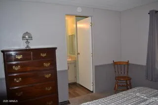 a bathroom with a granite countertop sink toilet and mirror
