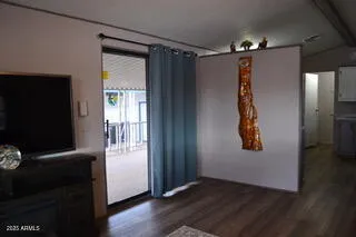 a view of a hallway with wooden floor and stairs