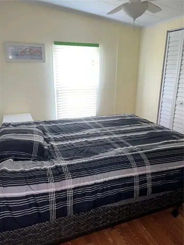 a view of bedroom with wooden floor