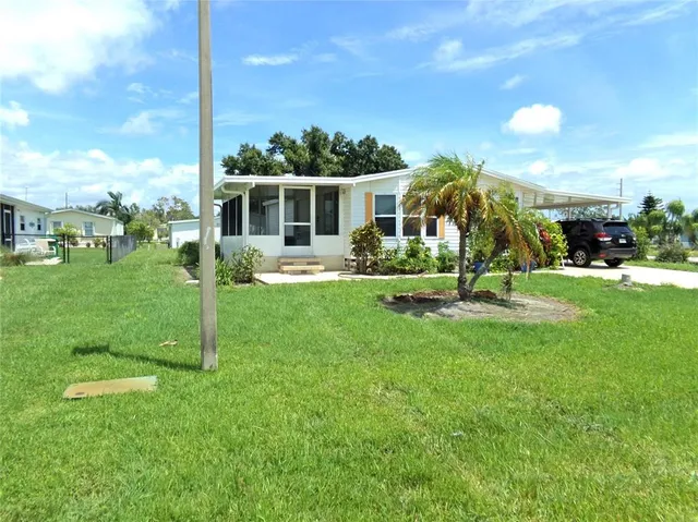 a view of a house with a backyard