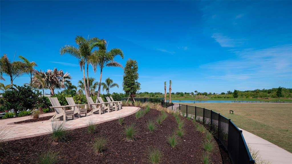18125 Gander Terrace Lakewood Ranch, FL 34211 - Photo 42 of 50 a view of a lake with a palm tree