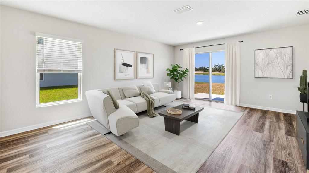 18125 Gander Terrace Lakewood Ranch, FL 34211 - Photo 7 of 50 a living room with furniture fireplace and a window