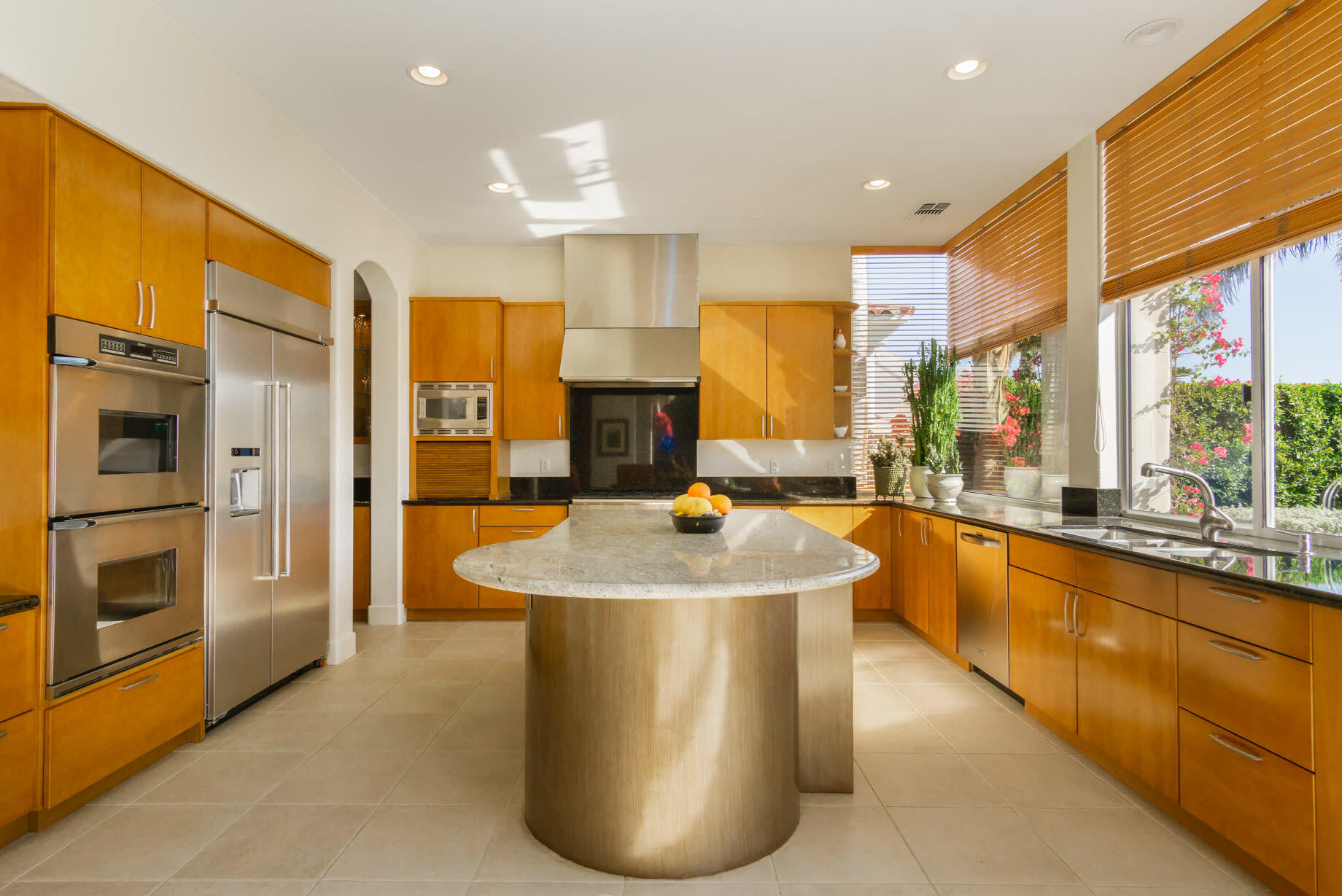 238 Loch Lomond Road Rancho Mirage, CA 92270 - Photo 16 of 44 a large kitchen with kitchen island a large window a sink and a refrigerator