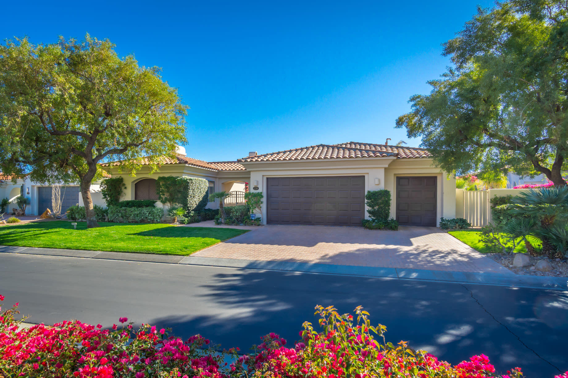238 Loch Lomond Road Rancho Mirage, CA 92270 - Photo 4 of 44 a front view of a house with a yard and garage