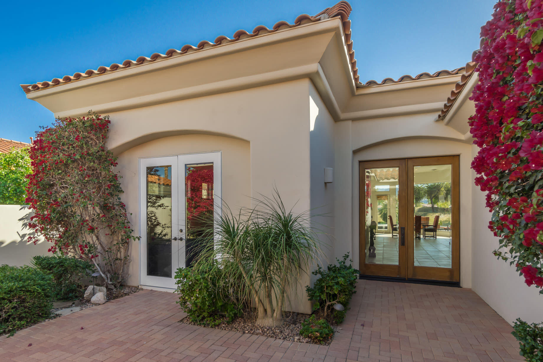 238 Loch Lomond Road Rancho Mirage, CA 92270 - Photo 6 of 44 front view of a house with potted plants