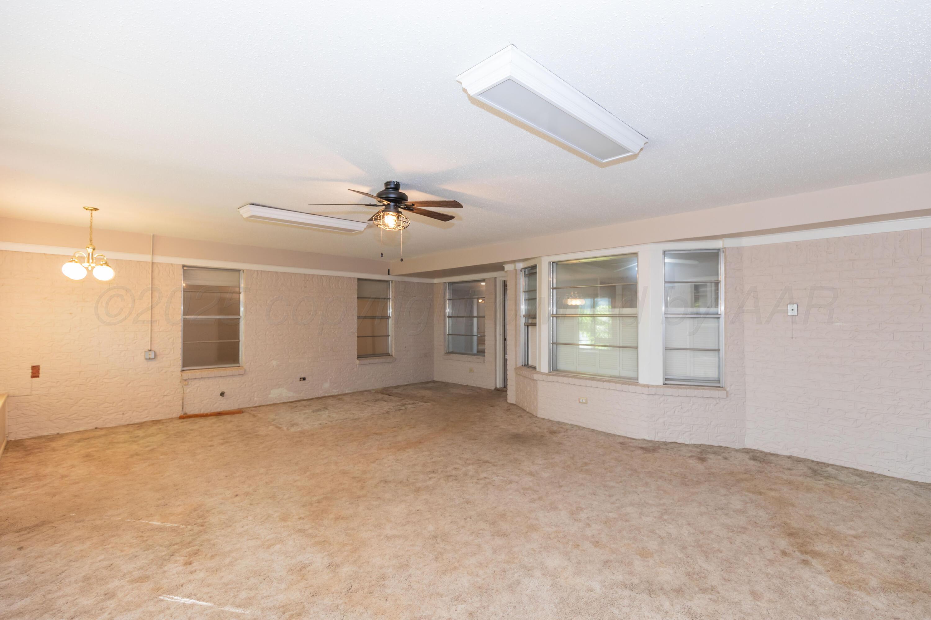 6710 Gainsborough Road Amarillo, TX 79106 - Photo 54 of 62 en empty room with windows and ceiling fan