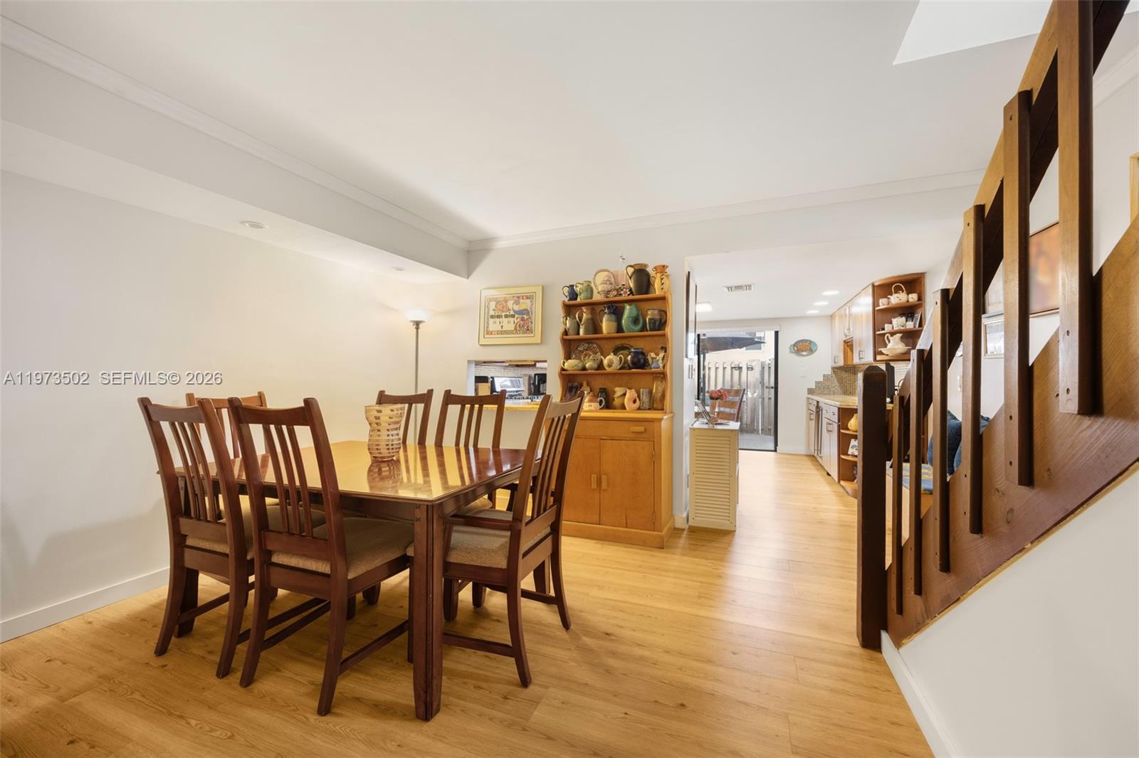 11353 Southwest 109th Road, Unit 55X Miami, FL 33176 - Photo 12 of 26 a dining room with furniture and a floor to ceiling window