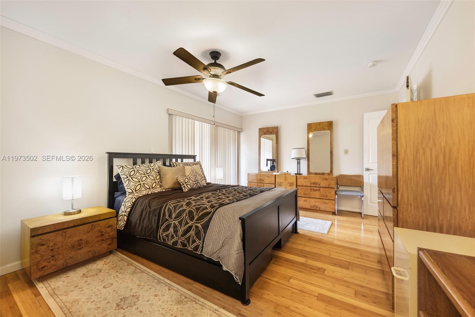 11353 Southwest 109th Road, Unit 55X Miami, FL 33176 - Photo 14 of 26 a bedroom with a bed and wooden floor