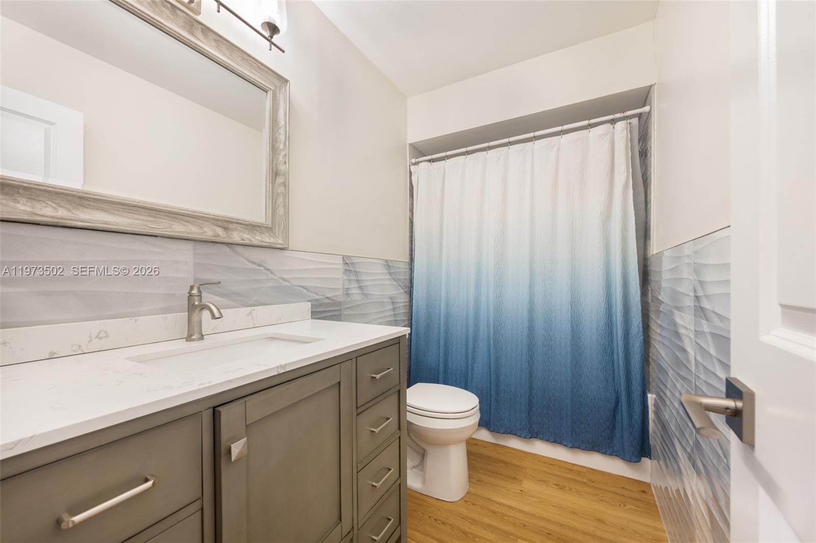 11353 Southwest 109th Road, Unit 55X Miami, FL 33176 - Photo 20 of 26 a bathroom with a sink a toilet and shower
