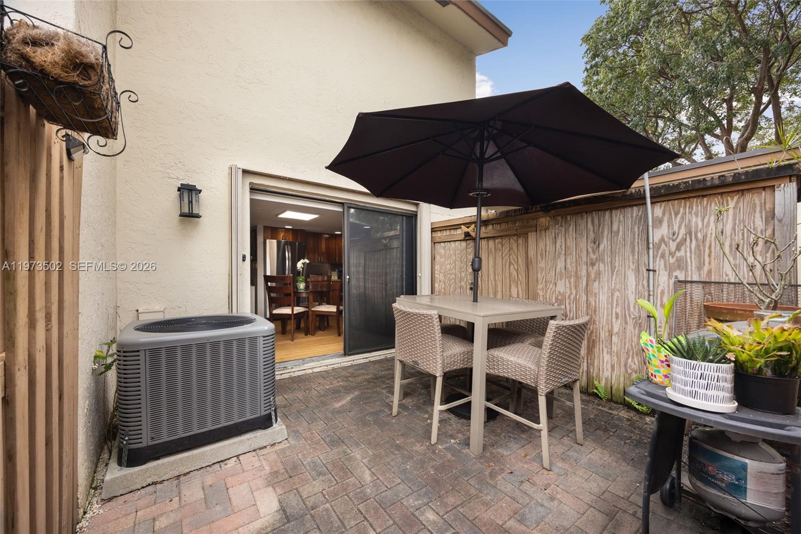 11353 Southwest 109th Road, Unit 55X Miami, FL 33176 - Photo 22 of 26 a view of a chairs and table in the back yard of the house