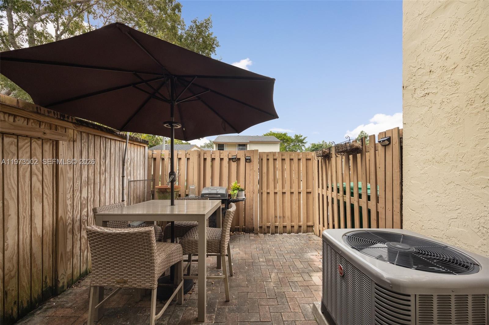 11353 Southwest 109th Road, Unit 55X Miami, FL 33176 - Photo 23 of 26 a patio with a table and chairs