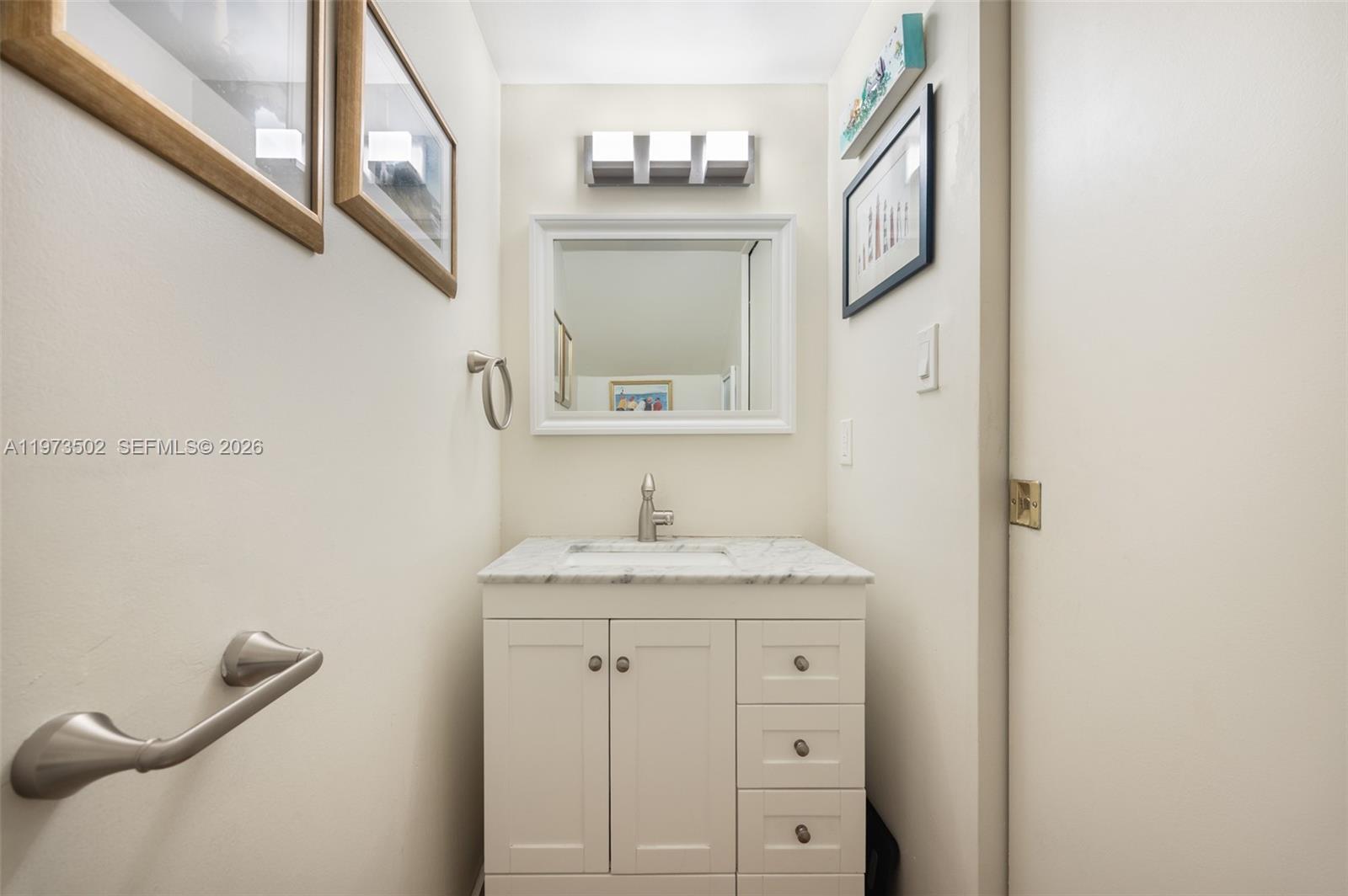 11353 Southwest 109th Road, Unit 55X Miami, FL 33176 - Photo 6 of 26 a bathroom with a granite countertop sink vanity and a mirror