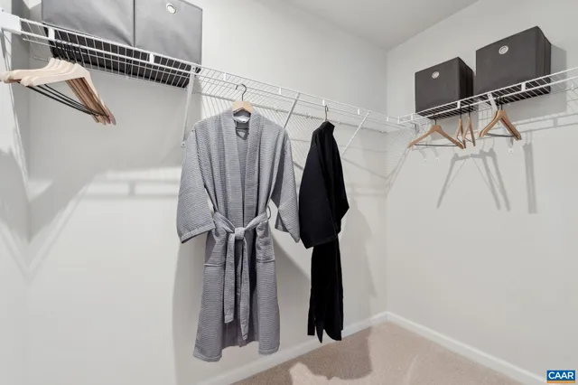 a view of walk in closet with clothes