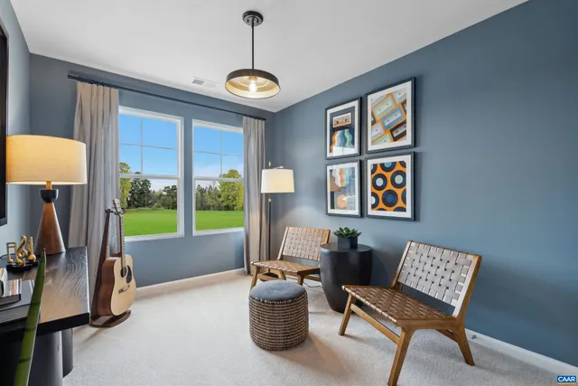 a living room with furniture and a floor to ceiling window