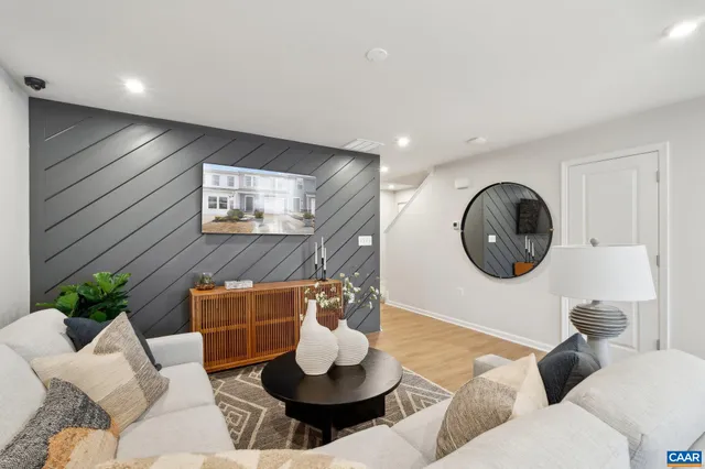 a living room with furniture and a mirror