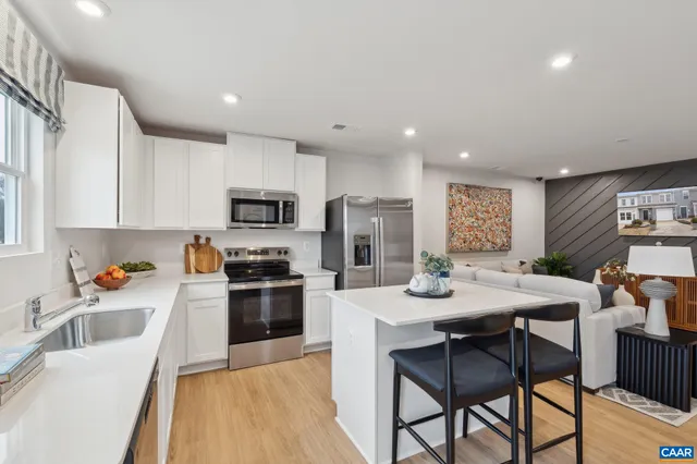 a kitchen with stainless steel appliances kitchen island granite countertop a sink and cabinets