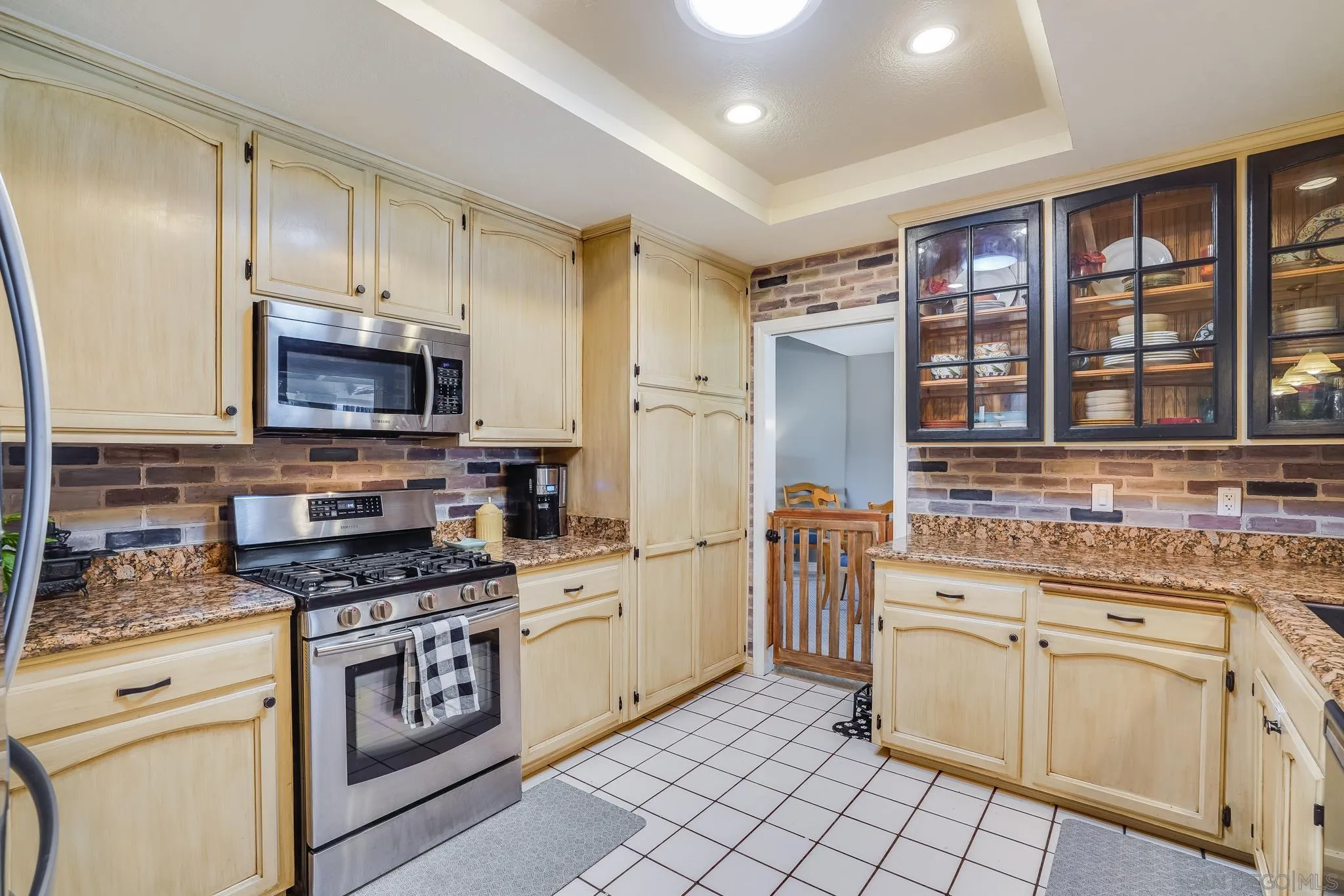 3764 Avocado Boulevard La Mesa, CA 91941 - Photo 15 of 66 a kitchen with stainless steel appliances a stove sink microwave and cabinets